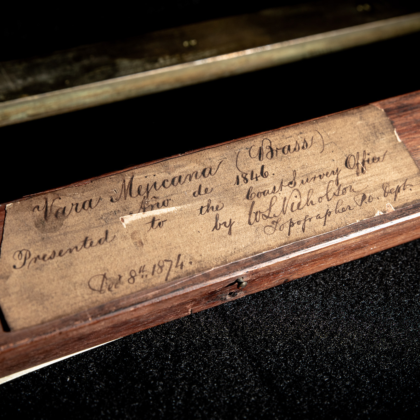 Label on the box holding one of the varas. It reads "Vara Mejicana (Brass), Ano de 1846, Presented to the the Coast Survey Office by WL Nicholson, Topographer P.O. Dept, Dec 8th, 1874