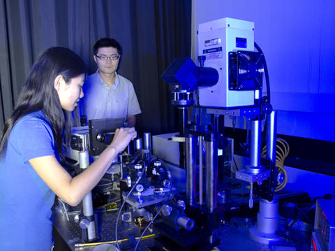 Guest researchers Qin Zhang (left) and Rusen Yan (right) align the sample.