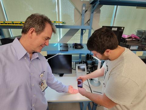 A man gets his fingerprints scanned to support the Mobile Fingerprint prize challenge evaluation.
