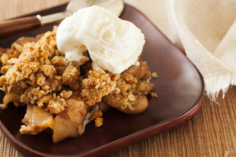 photo of apple crisp with whipped cream on plate