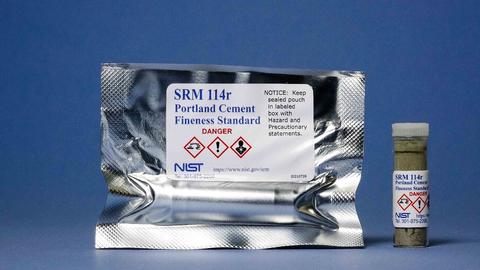 Photograph of SRM 114r Portland Cement Fineness Standard showing labeled mylar bag and vial.