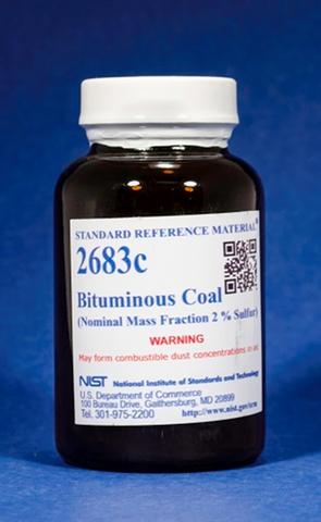Photograph of a labeled amber bottle containing SRM 2683c Bituminous Coal.