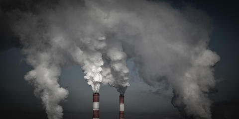 Photograph of smoke emissions from industrial stacks. 