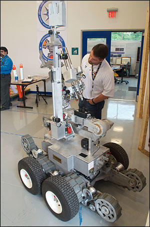 Matthew Hickman, Department of Homeland Security Program Manager, with a Remotec Andros bomb-disposal robot. 