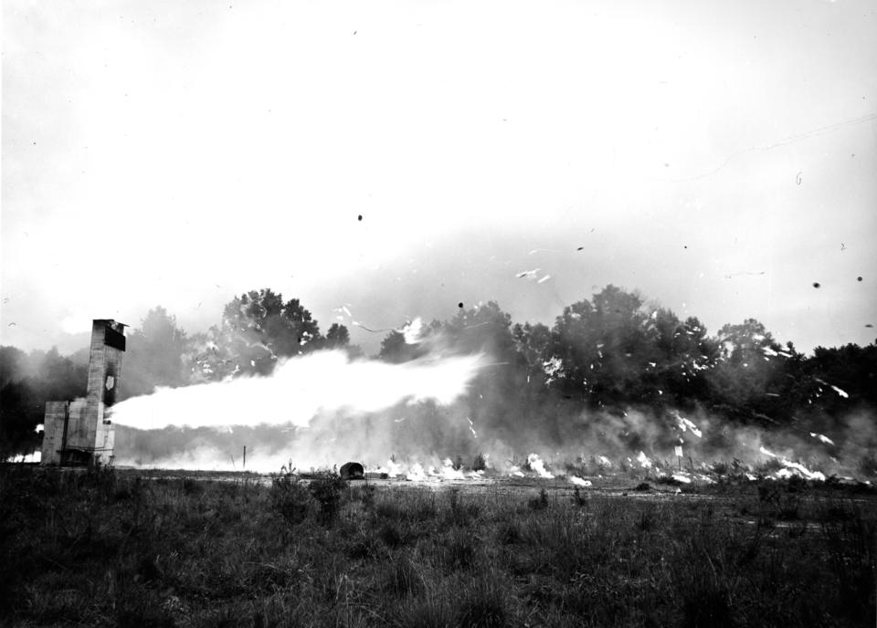 Black and white photograph of a underground shelters on fire. 