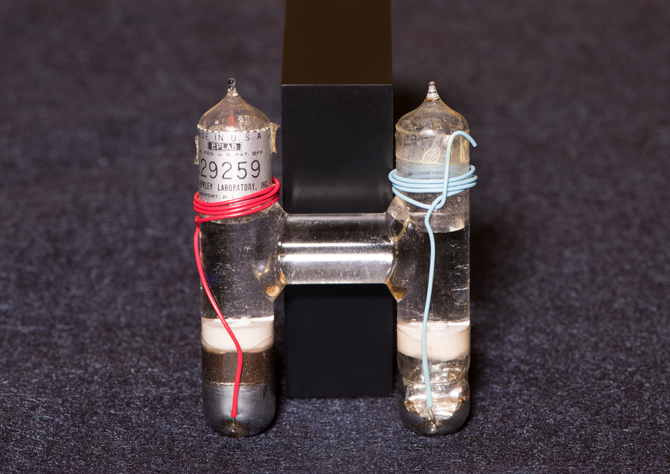 inside of a Weston cell. Two cylinders, one with red wire, one with blue wire