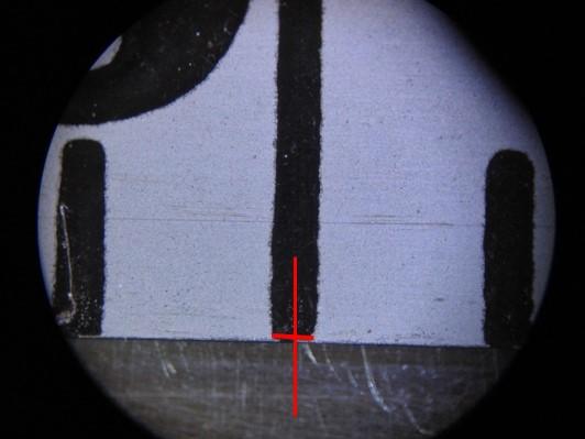 Hash marks on a tape measure, as viewed under a microscope.