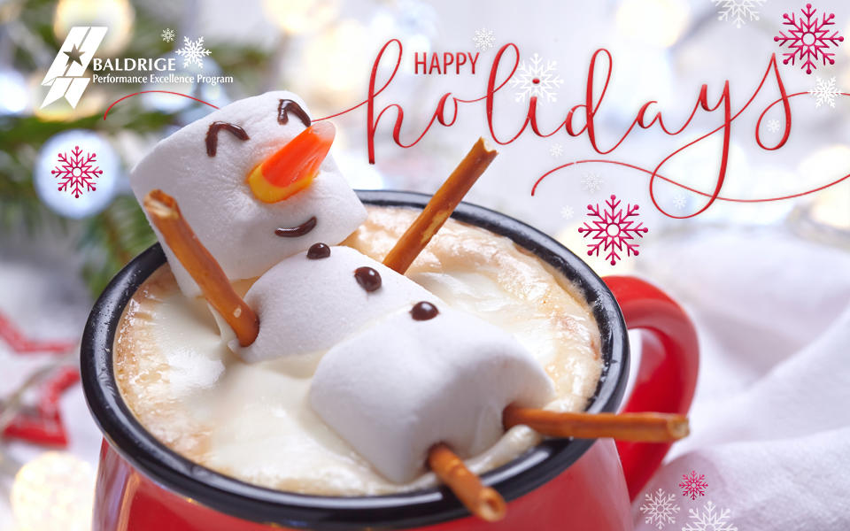 Happy Holidays from the Baldrige Performance Excellence Program. Showing a marshmallow snowman laying in a red cup full of hot chocolate with snowflakes falling. 