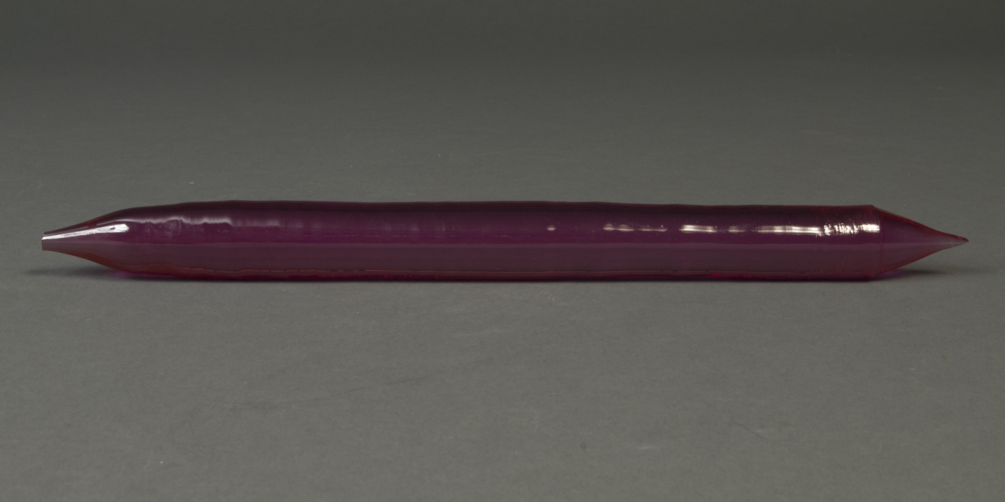 A purple crystal cylinder, pointed at the ends