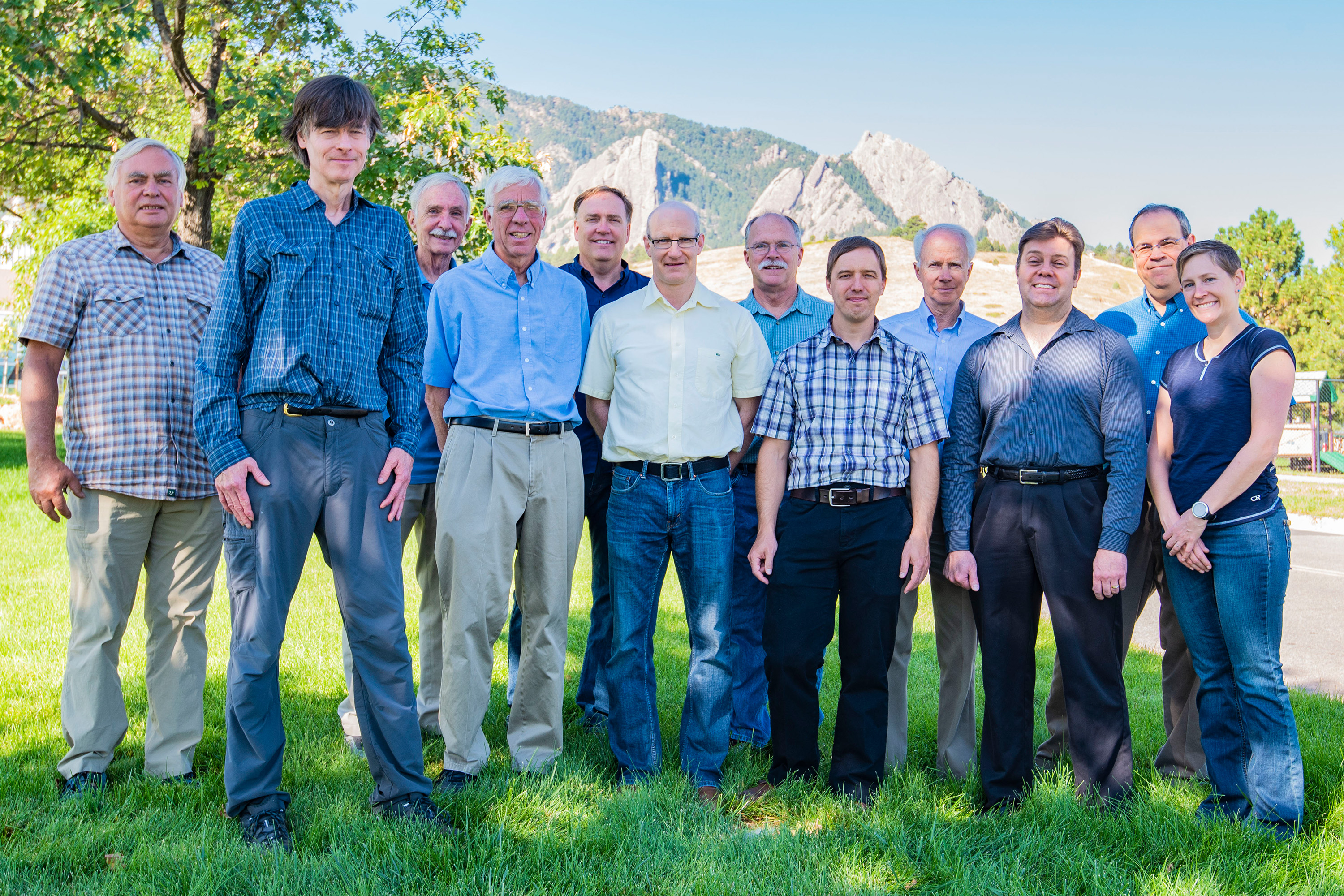 Portrait of NIST Boulder researchers standing in a field in front of the Flatiron Mountains