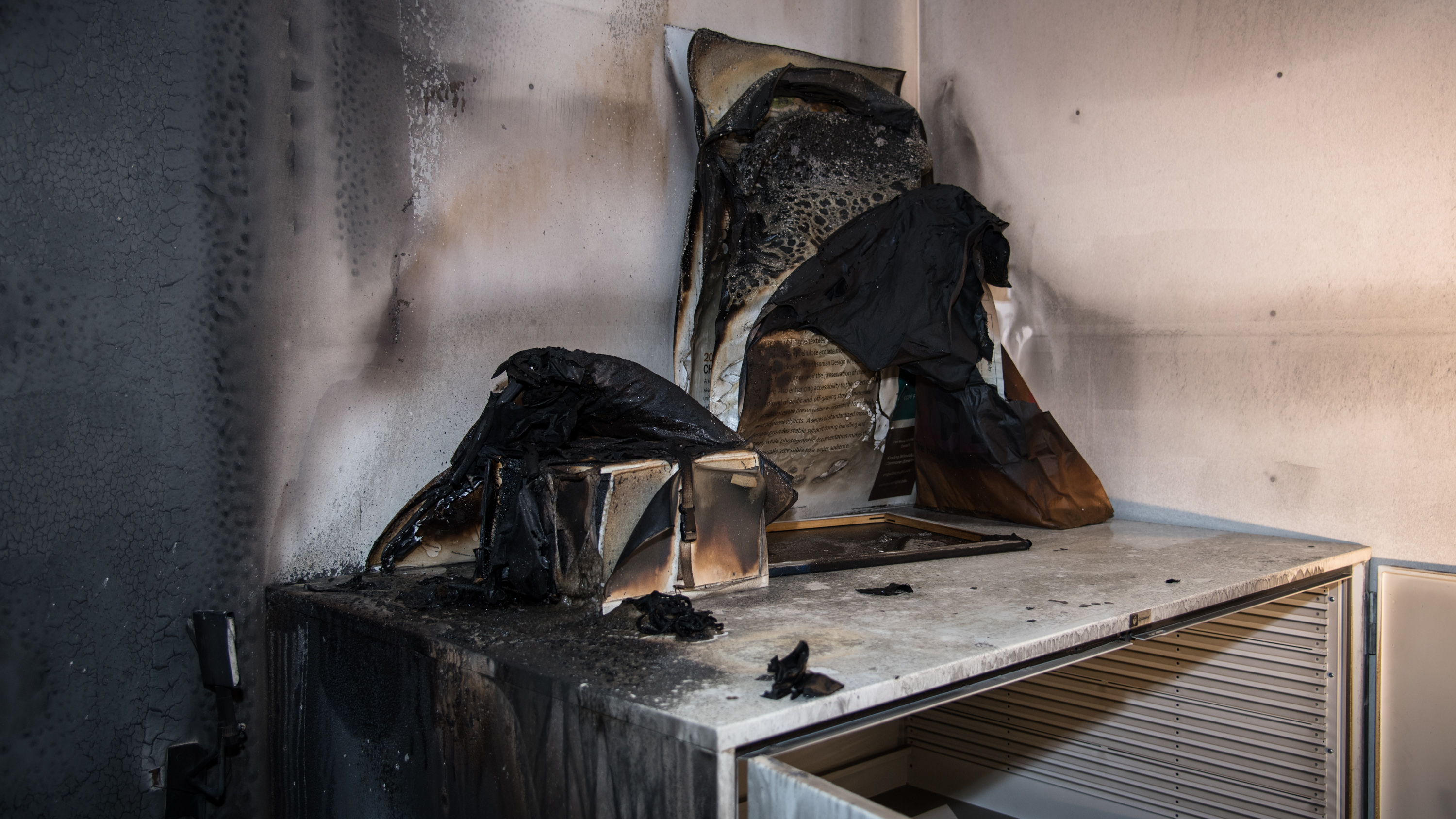 charred books and papers on a table