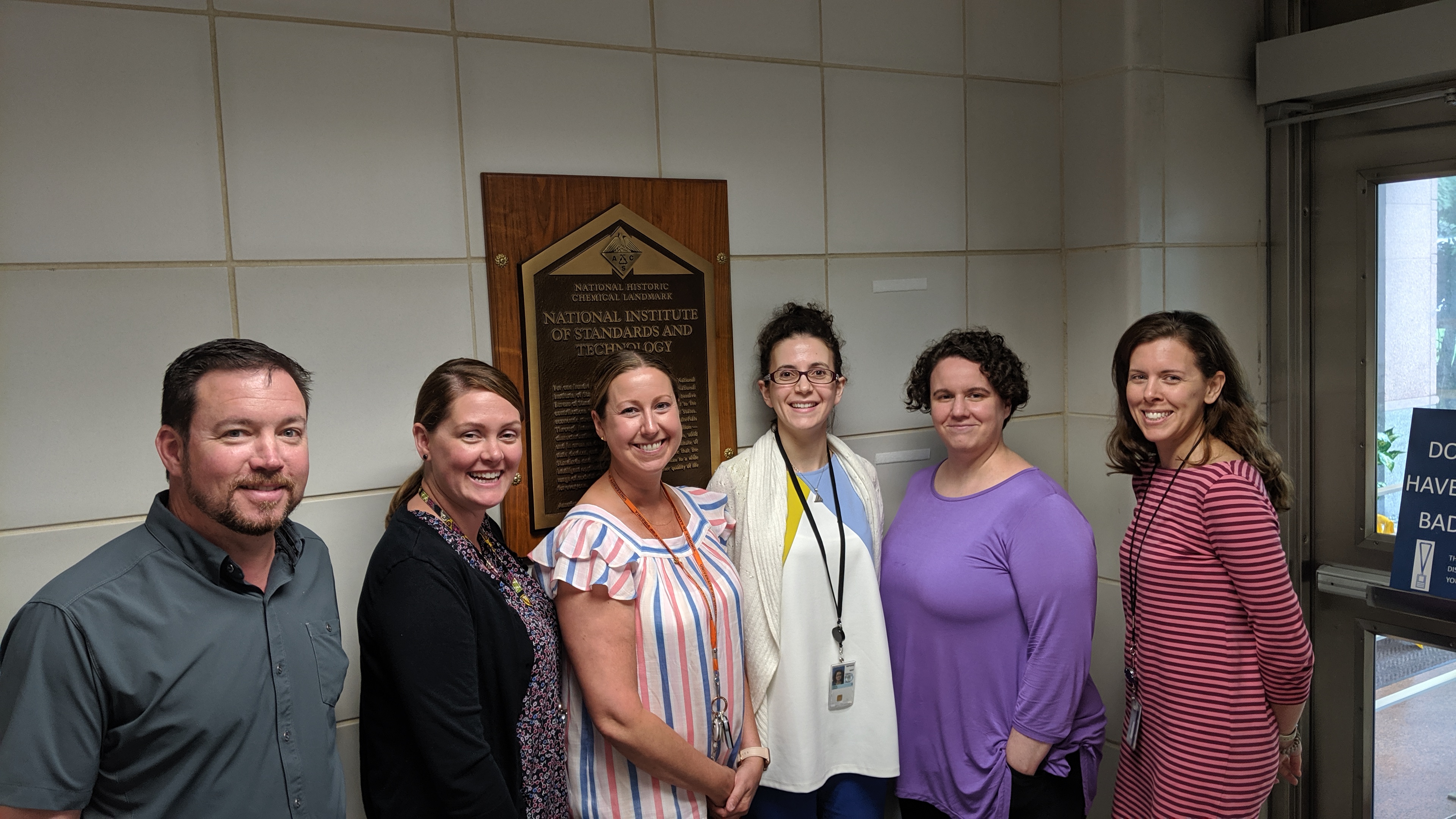 group photo of five female and one male scientist