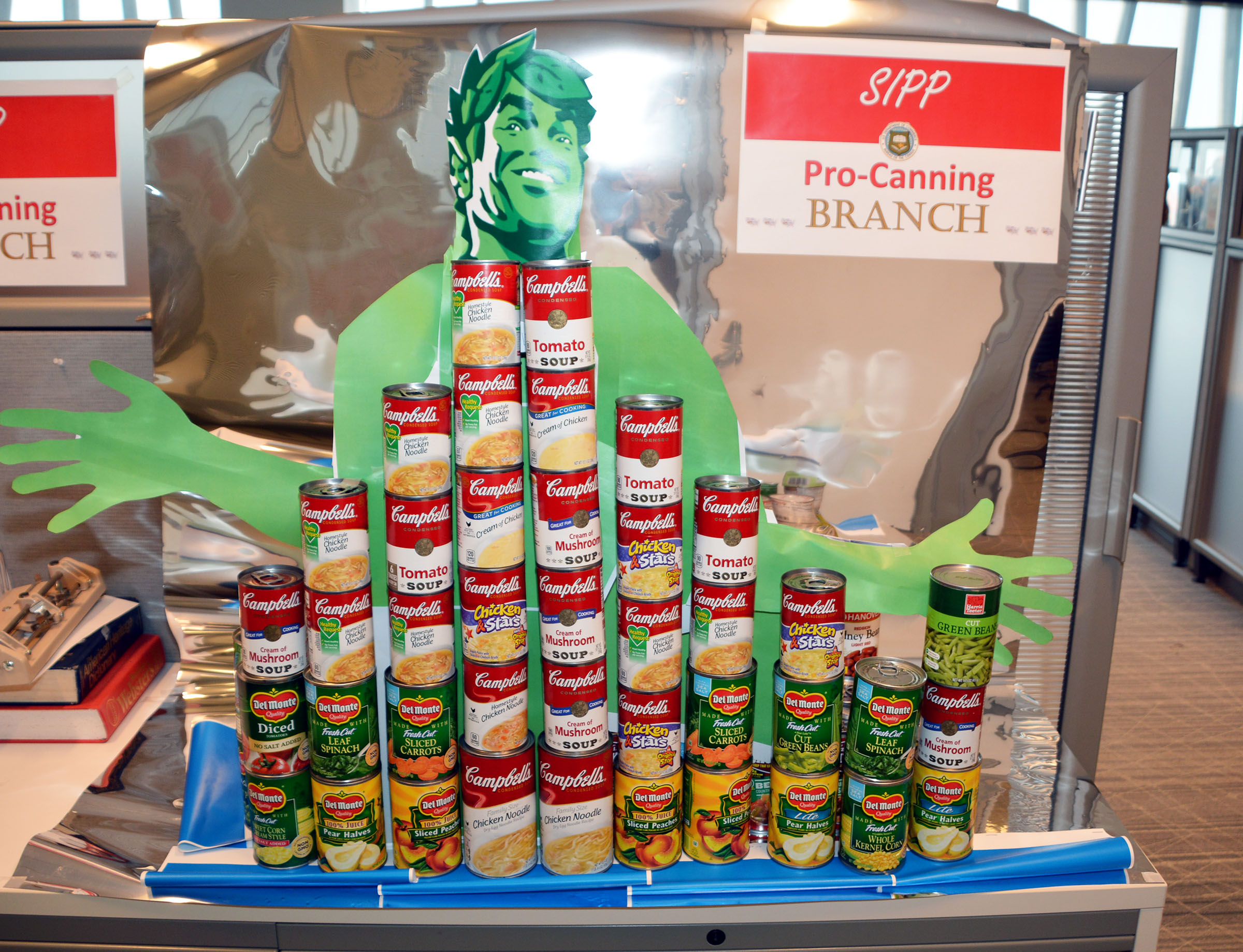 A tower of cans and the Jolly Green Giant for the 2019 CFC CANstruction Food Drive at the Census Bureau