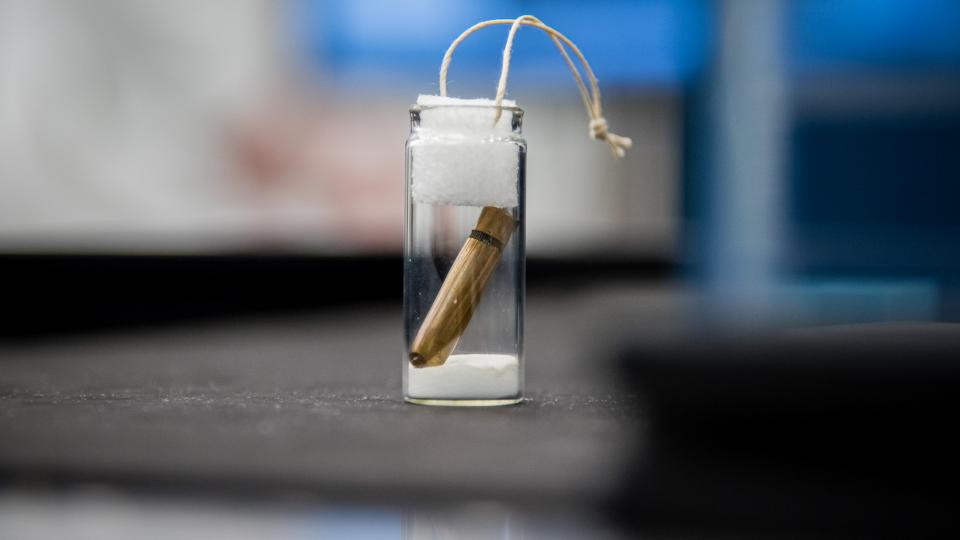 a bullet inside a small glass vial