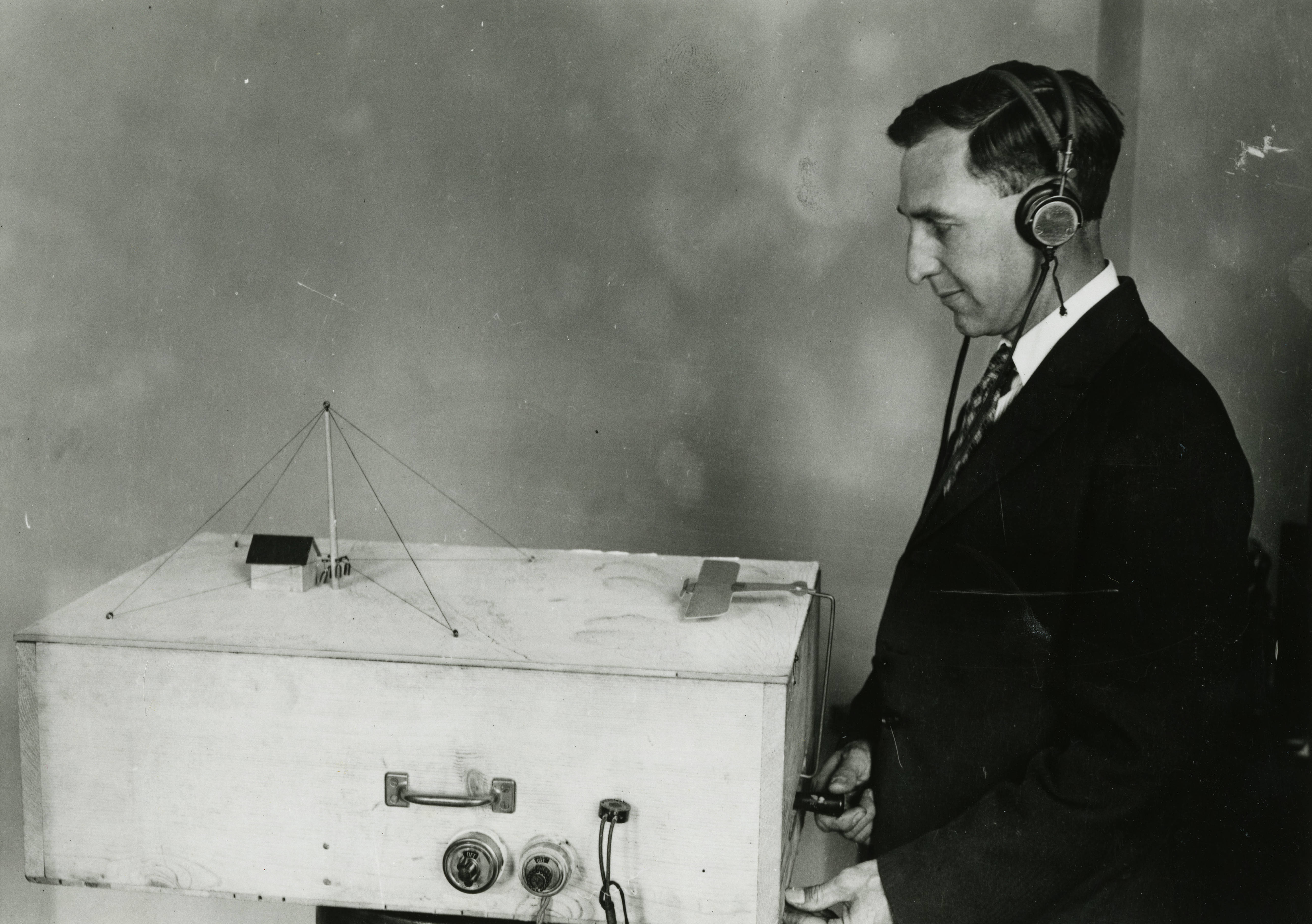 physicist Francis Dunmore operates a model illustrating the radio beacon system used in guiding aircraft