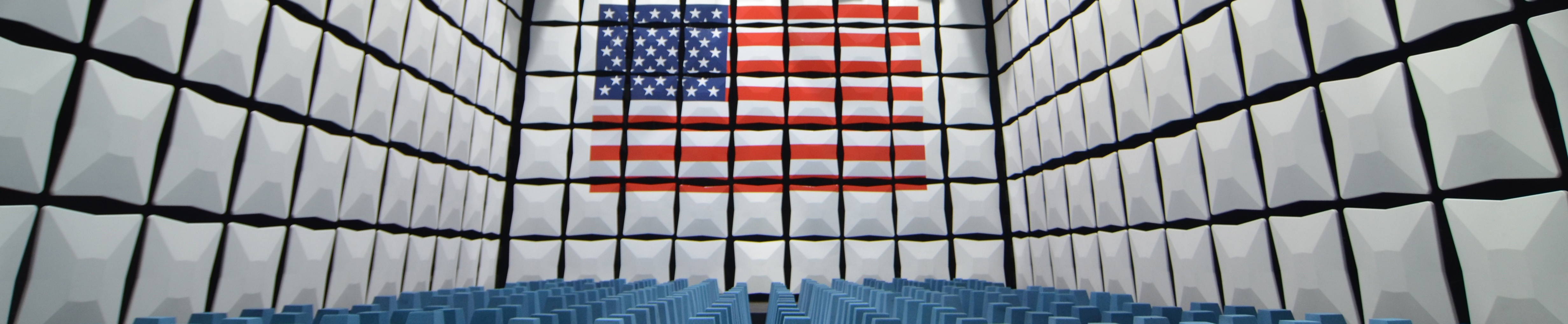 room with square boxes on wall. most boxes are white. some form a pattern of US flag