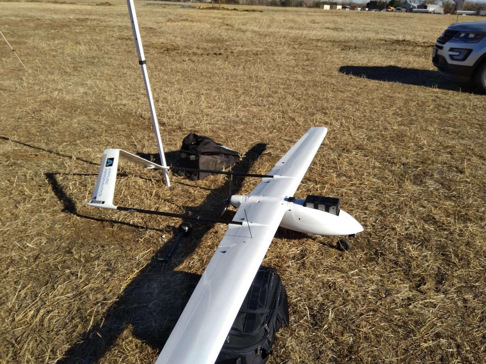 white drone plane on the ground
