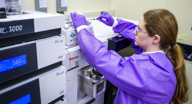 Women in purple in medical clothing analyzing specimen 