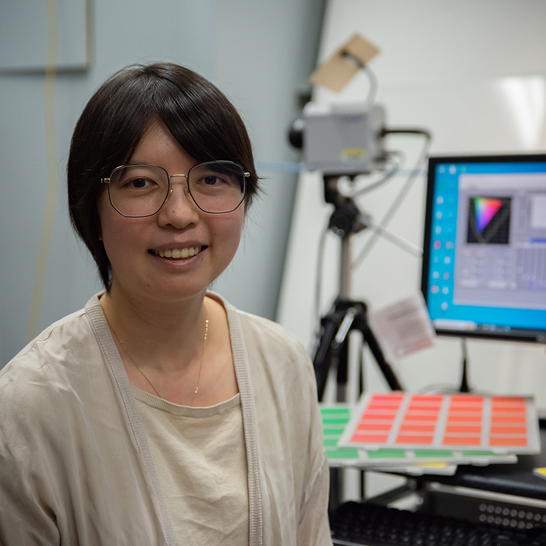 Jane Li at her desk in lighting lab