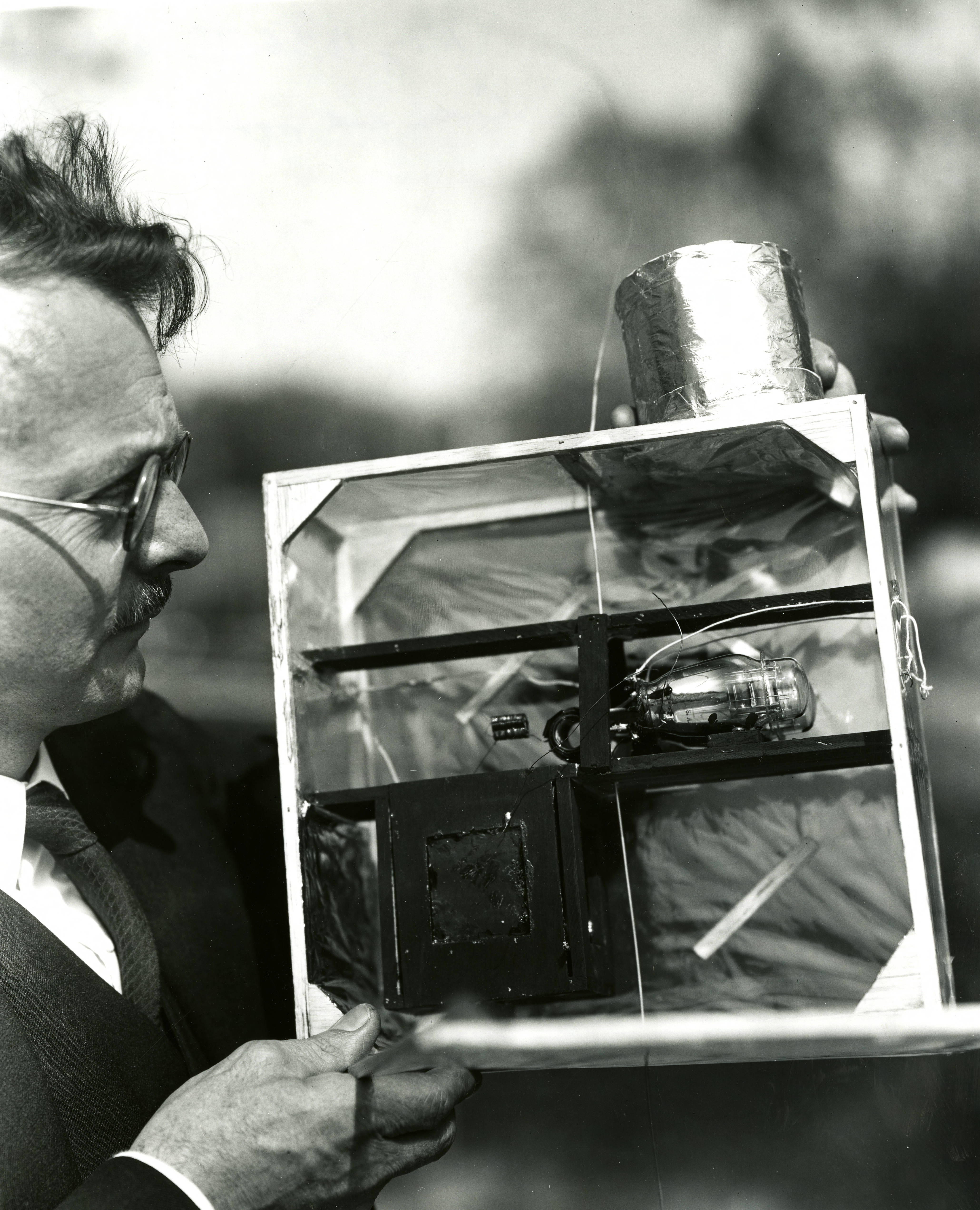 Photograph of Leon F. Curtiss with a radiosonde in May 1936.