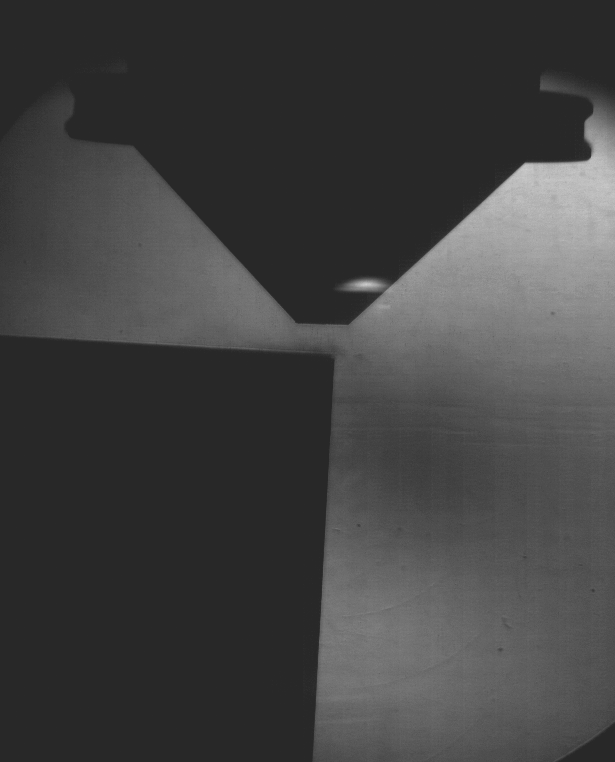 Black and white gif of particles and gas flowing from a nozzle. 