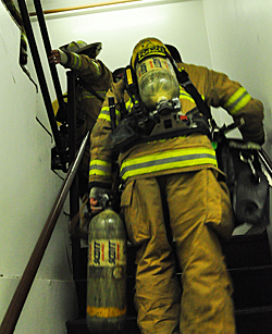 firefighters climbing stairs