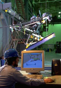 A worker programming  the RoboCrane TETRA.