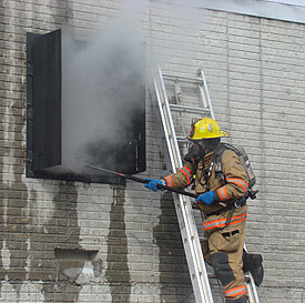 fire fighter ventilating a building