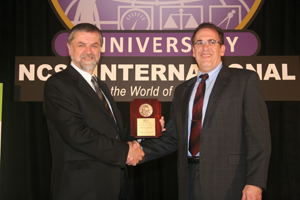 Mike Lombardi (right) at the Wildhack Award presentation. At left is Derek Porter, past president of the National Conference of Standards Laboratories International. Photo courtesy of NCSL International
