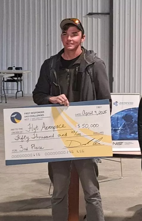 Person holding a large check