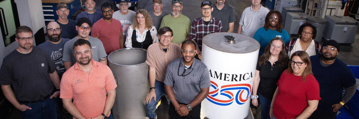 A group of people around a cylindrical time capsule
