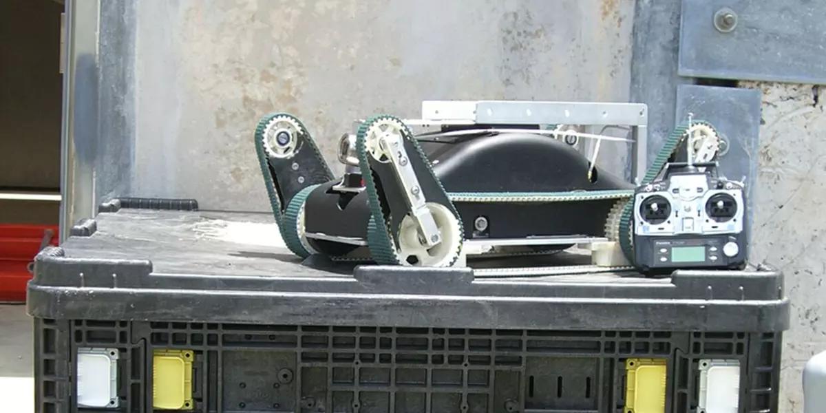 Photo of an urban search and rescue robot and its control unit sit atop a packing crate