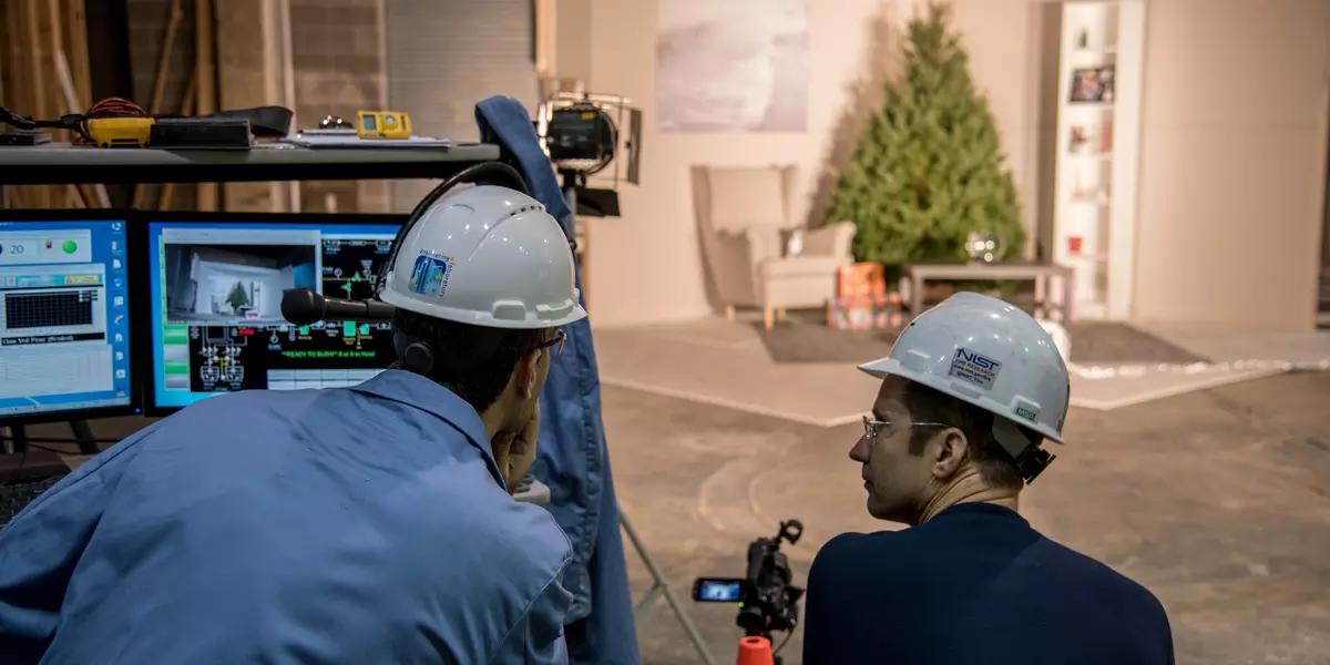 Two engineers observe the scene for the Christmas tree burn