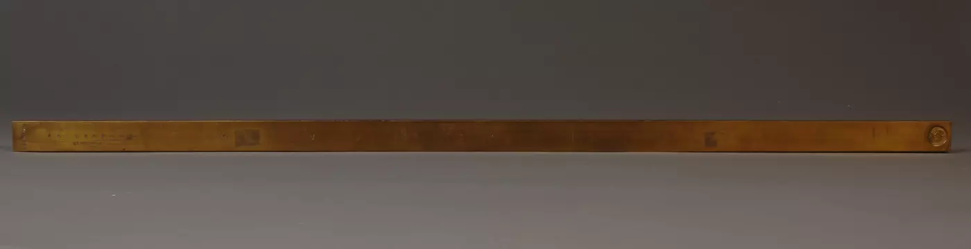 Brass Mexican Vara on gray background