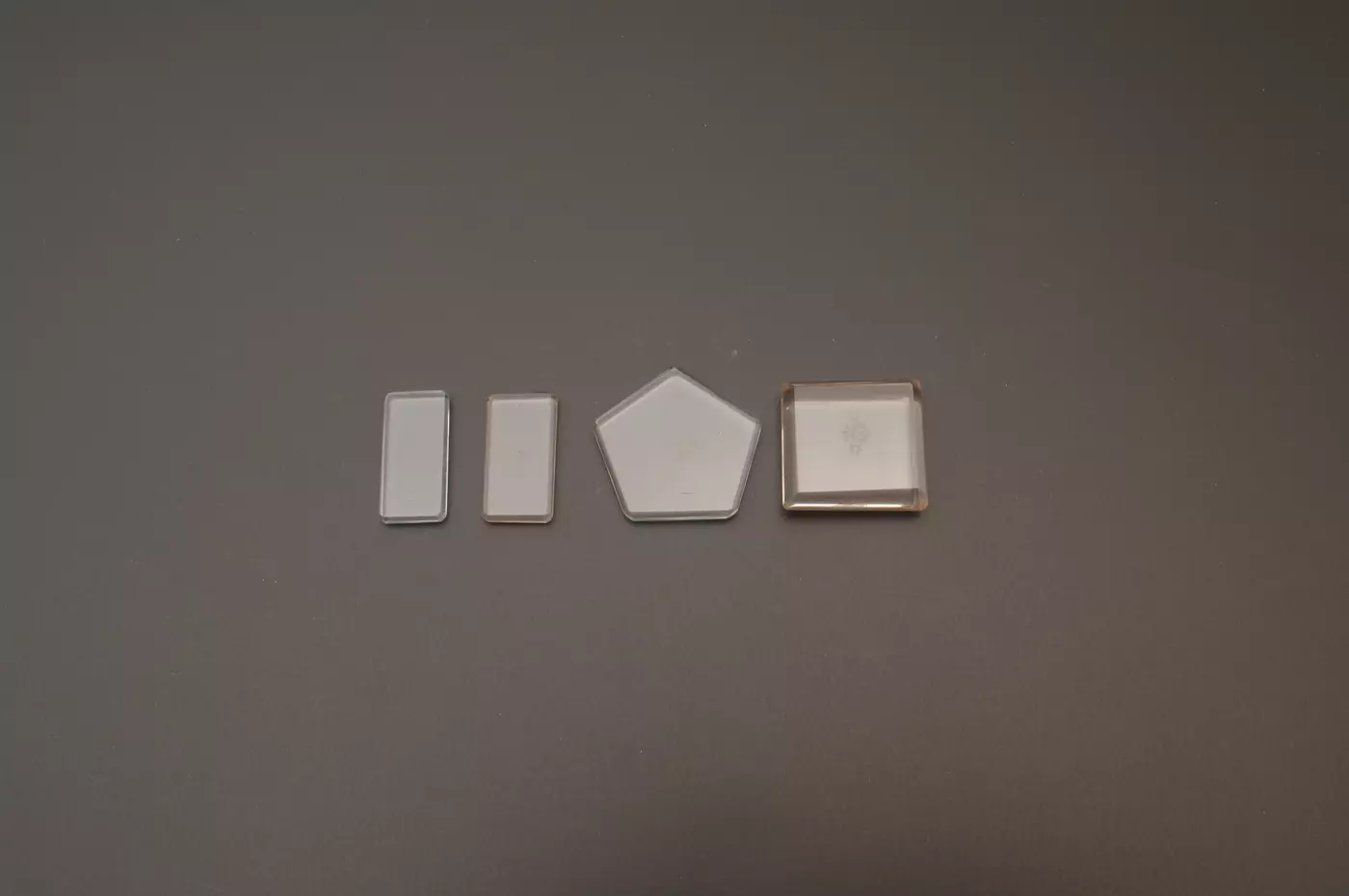 Set of 4 small solid glass weights in rectangle and pentagon shapes 