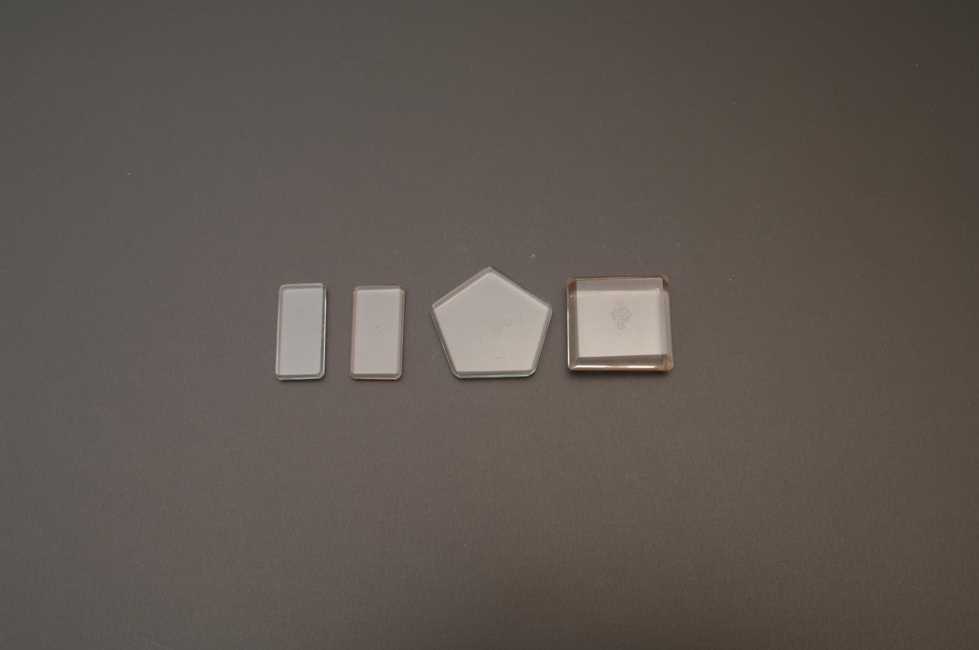 Set of 4 small solid glass weights in rectangle and pentagon shapes 