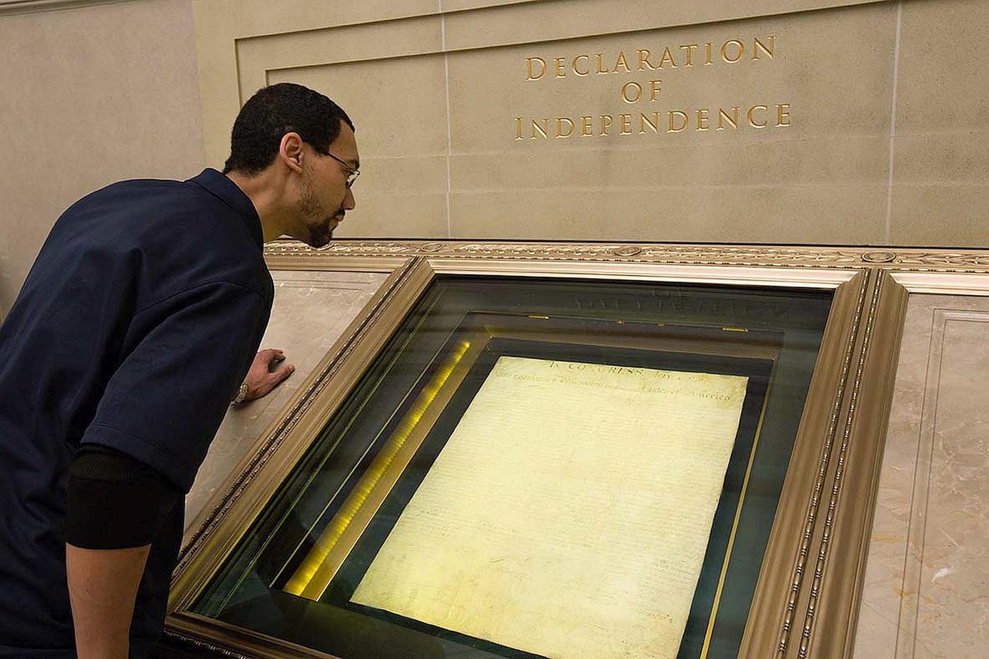 A man looking at the Declaration of Independence in its NIST-designed and manufactured encasement