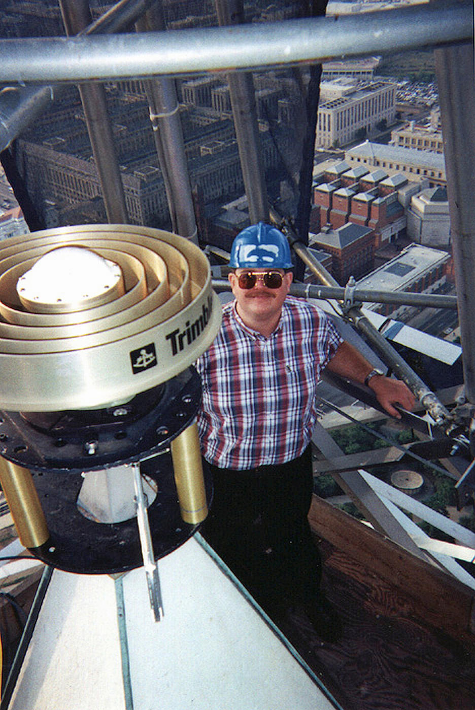 NIST Engineer stands on scaffolding at the top of the Washington Monument