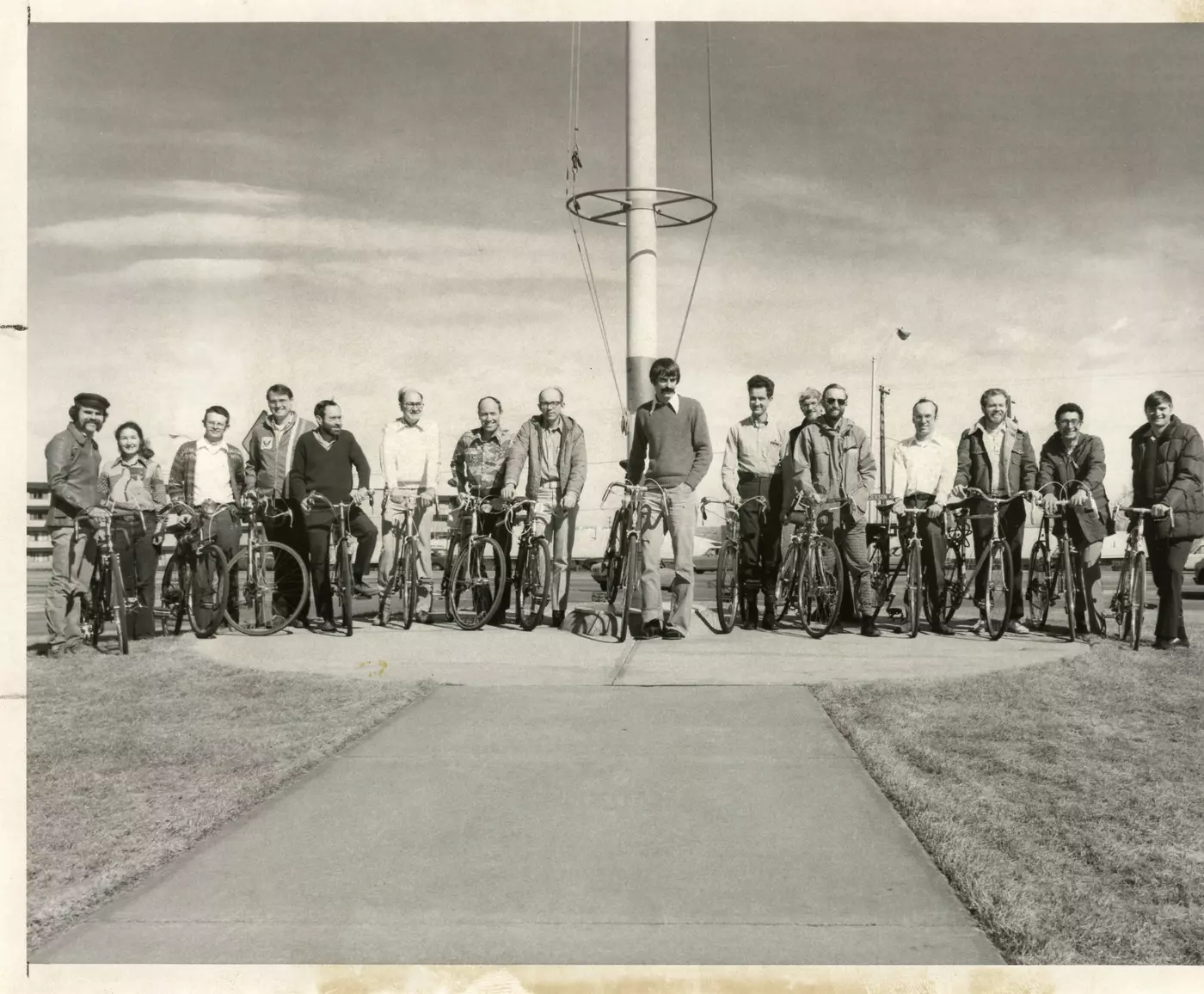 A group of 16 people with their bikes
