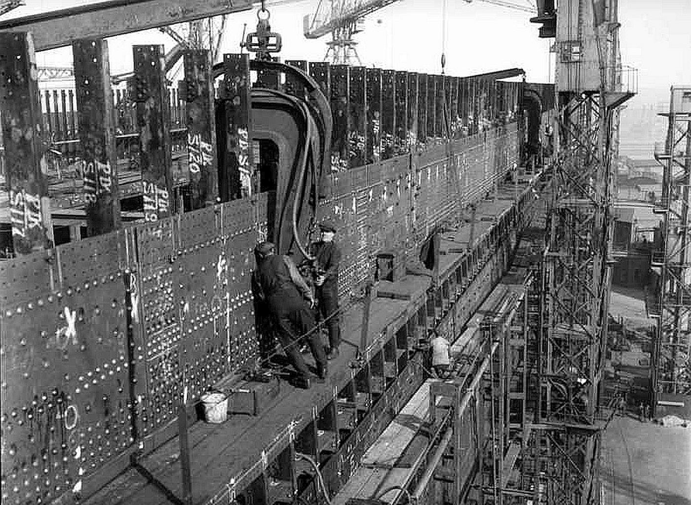 Photo of workers installing rivets in the Titanic's hull