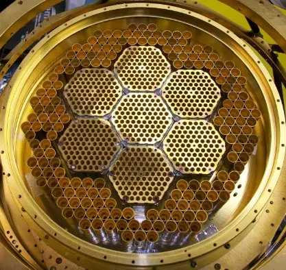 Circular gold-colored plate has seven smaller circles in the center.