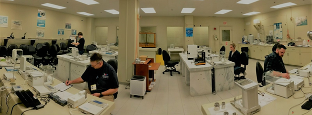 Photo of Mass Metrology Seminar student metrologists engaged in lab work activities.