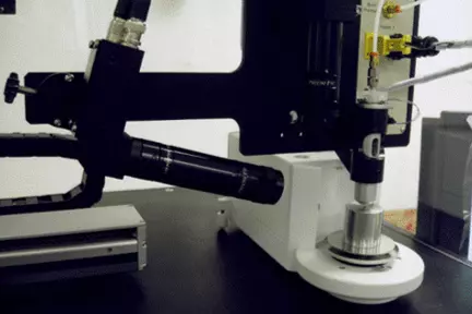 a drop-on-demand dispenser fed by a reservoir of standard solution