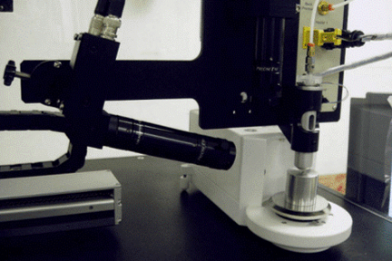 a drop-on-demand dispenser fed by a reservoir of standard solution
