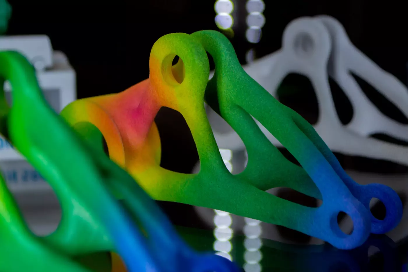 an abstract rainbow colored shape 3D printed by fusing powdered material together