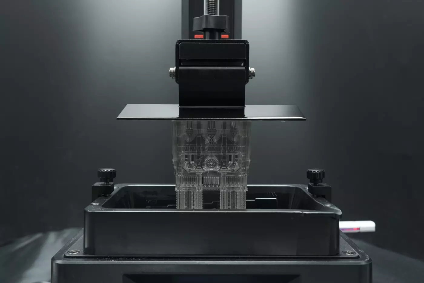 a complex architectural model is being produced by suspension in a vat of photopolymer resin and ultraviolet (UV) curing