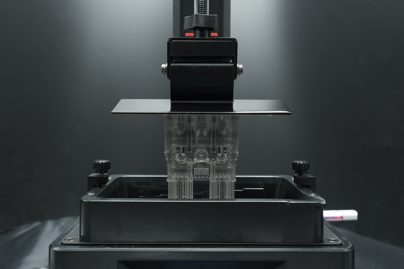 a complex architectural model is being produced by suspension in a vat of photopolymer resin and ultraviolet (UV) curing