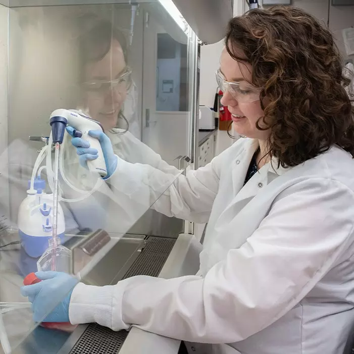 NIST researcher Jerilyn Izac harvests cells from a culture in her lab.