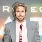 Actor Ryan Gosling standing in front of a Project Hail Mary movie promotional poster. 