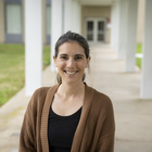 Stephanie Servetas poses smiling outdoors on the NIST Gaithersburg campus.